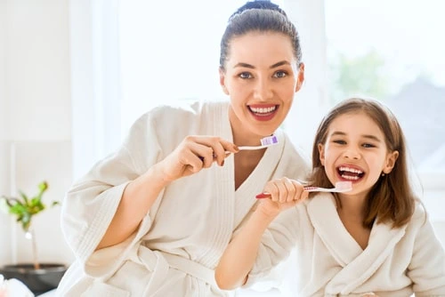 How do you teach a child to brush his teeth properly